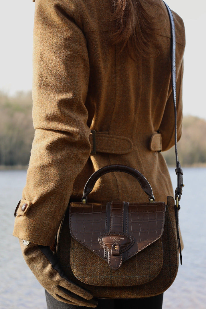 TWEED SADDLE BAG ON WOMANS BACK INFRONT OF LAKE