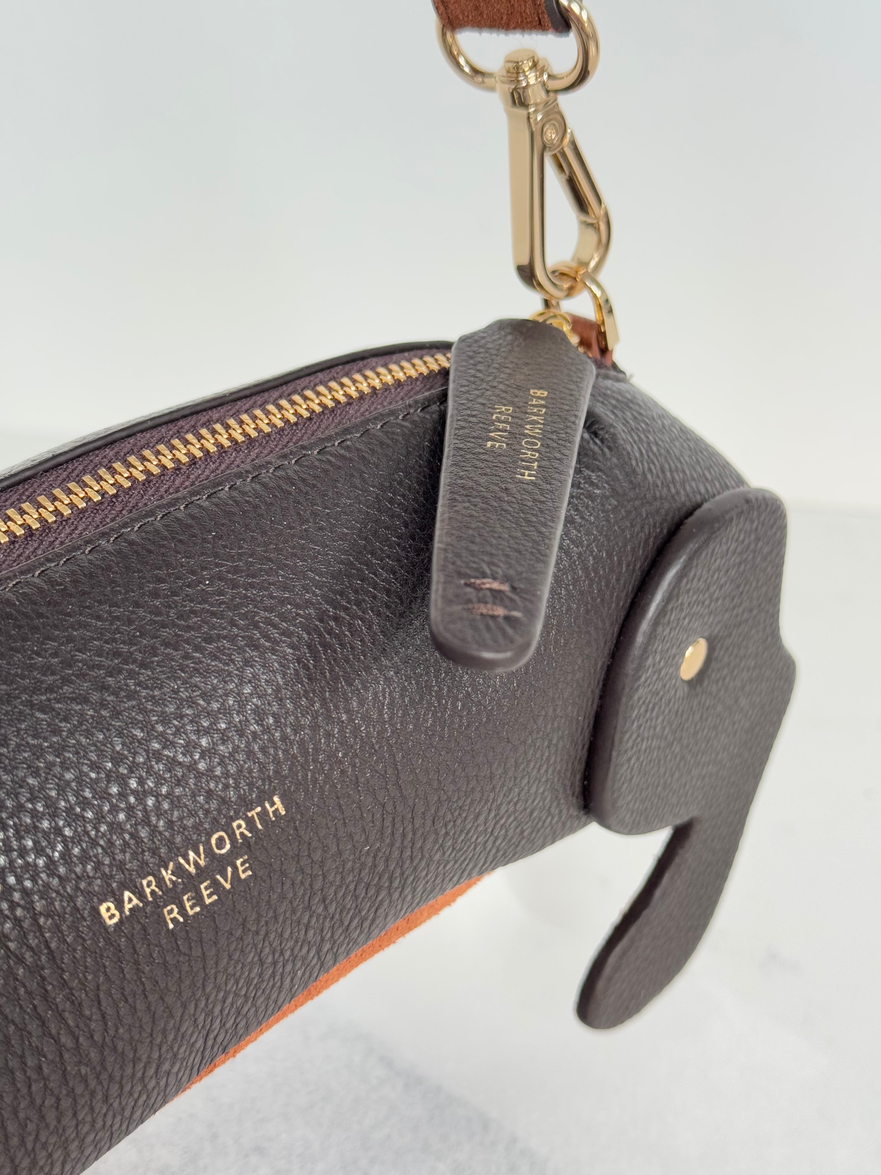 Sausage dog bag with chcolate leather exterior and tan suede tummy. clip fitting shows attachment for shoulder strap