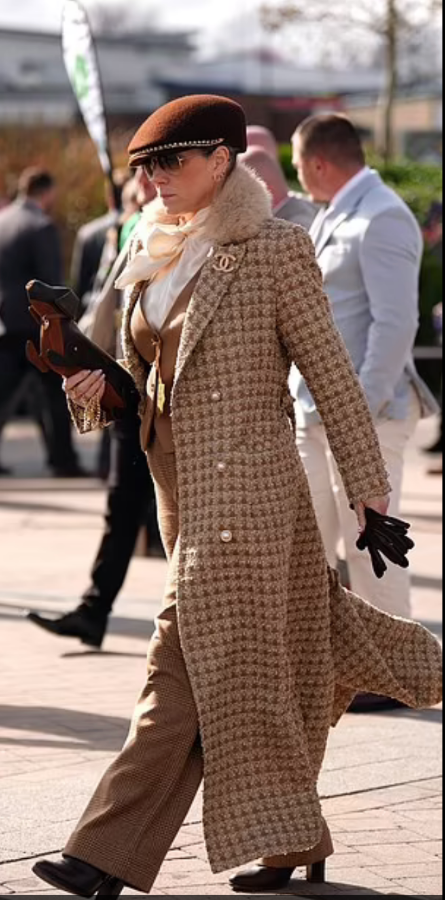 women in tweed suit with a hat and a sausage dog handbag