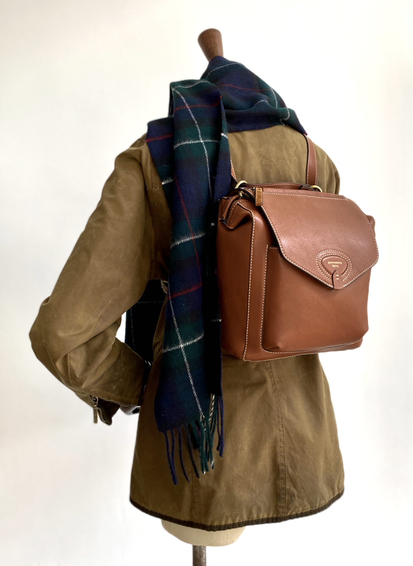 Tan Leather Bramham rucksack by Barkworth Reeve on a mannequin wearing green waxed country jacket