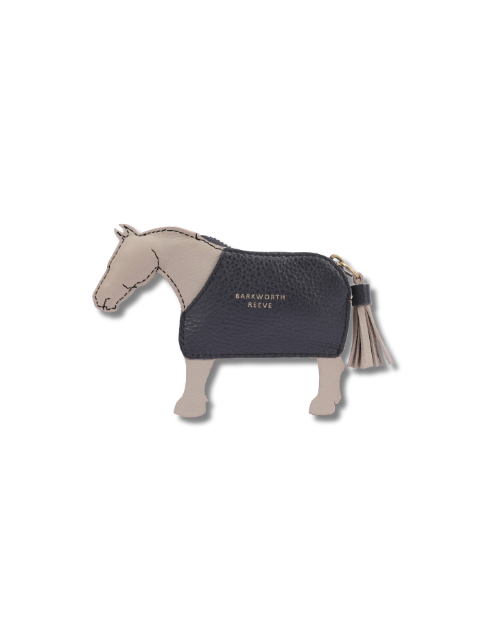 light grey leather coin purse in the shape of a pony with a navy coat. tassel tail zipper