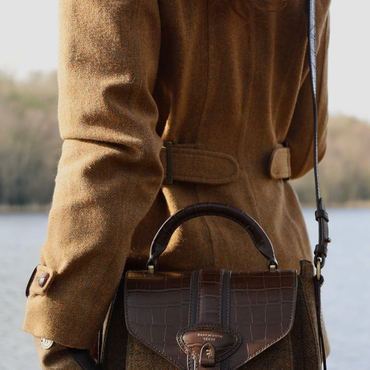 TWEED SADDLE BAG ON WOMANS BACK INFRONT OF LAKE