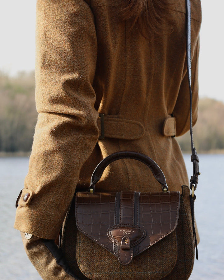 TWEED SADDLE BAG ON WOMANS BACK INFRONT OF LAKE
