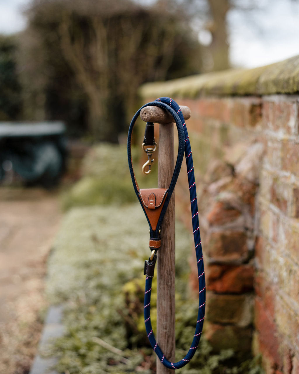 Barkworth Reeve Lead with intergrated poop pouch on a fork in a garden by a wall 