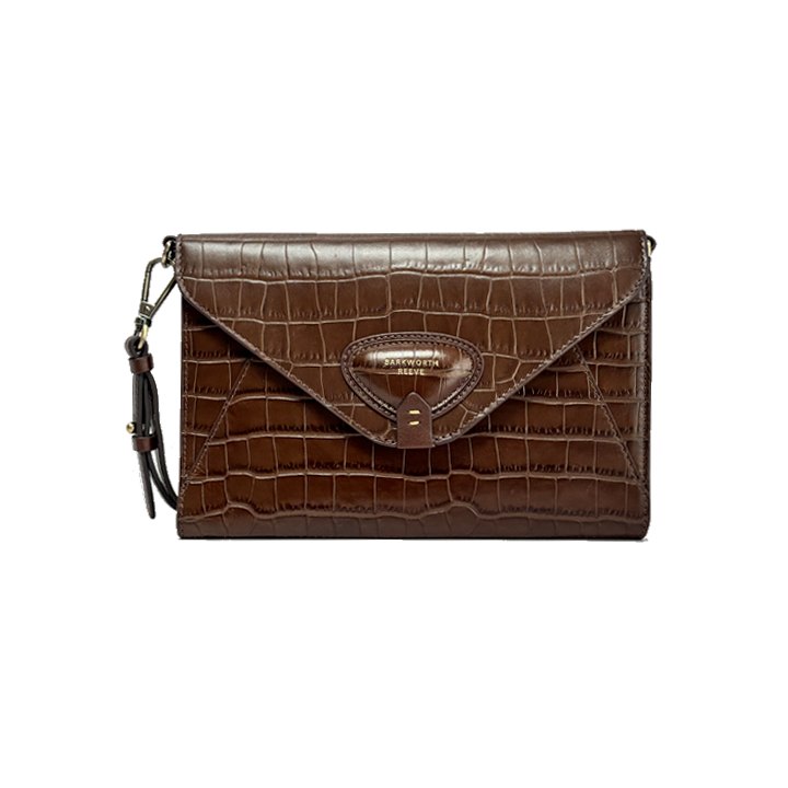 Brown crocodile-patterned clutch bag on a white background