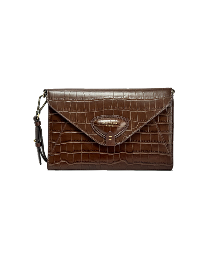 Brown crocodile-patterned clutch bag on a white background