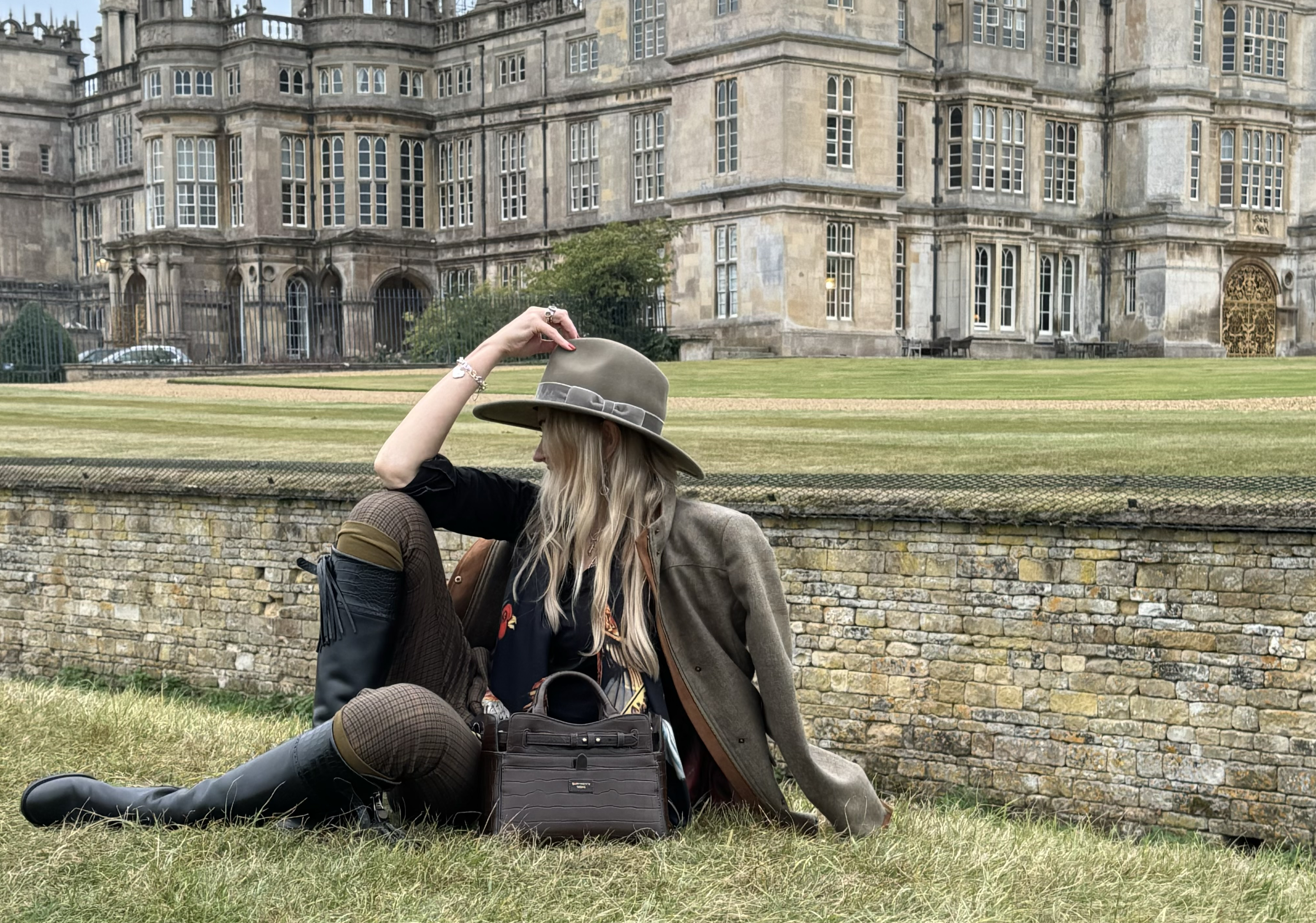 Chocolate Crocodile Leather Ambridge handheld bag by Barkworth Reeve in front of Burghely House