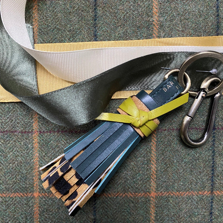 GREEN LEATHER AND LEAOPRD TASSEL LAID ON TWEED