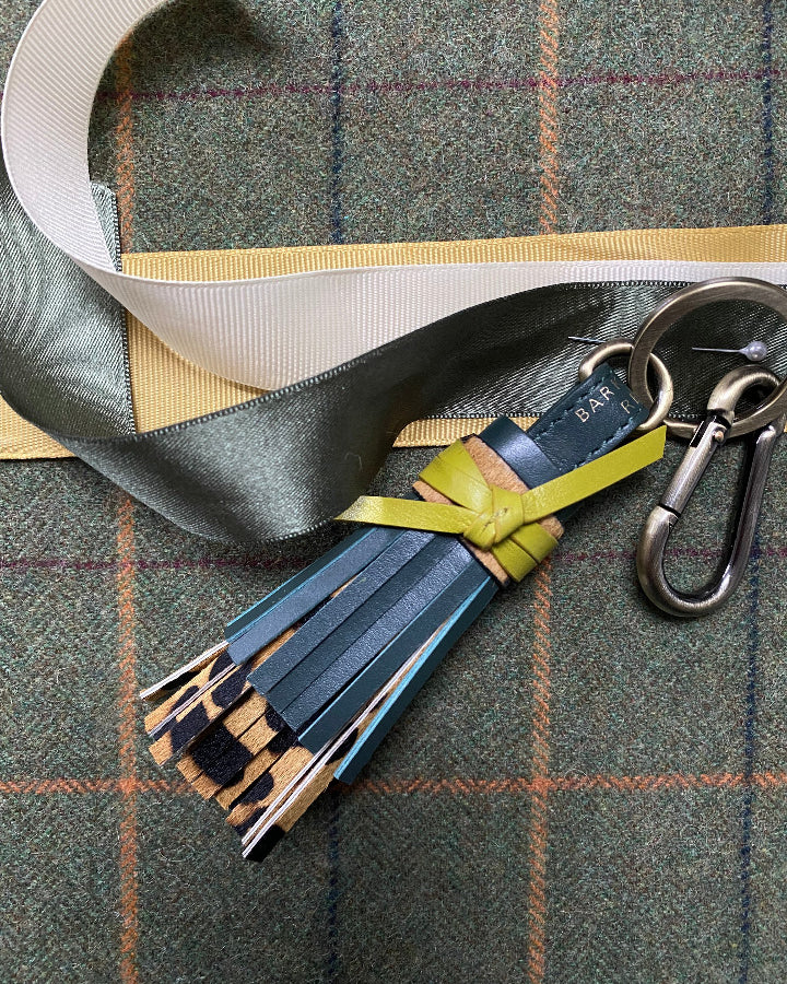GREEN LEATHER AND LEAOPRD TASSEL LAID ON TWEED