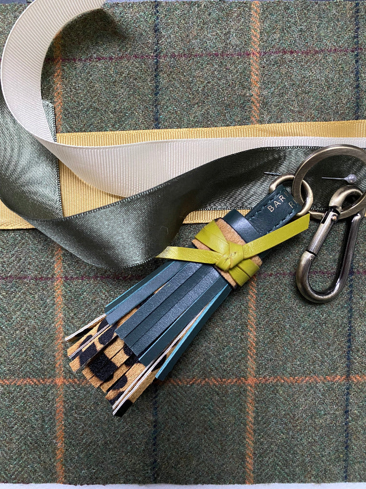 GREEN LEATHER AND LEAOPRD TASSEL LAID ON TWEED