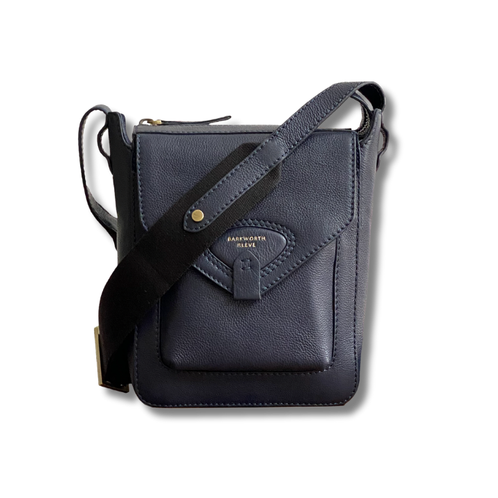 navy leather cross body bag with flap, pocket and webbing cross body strap 