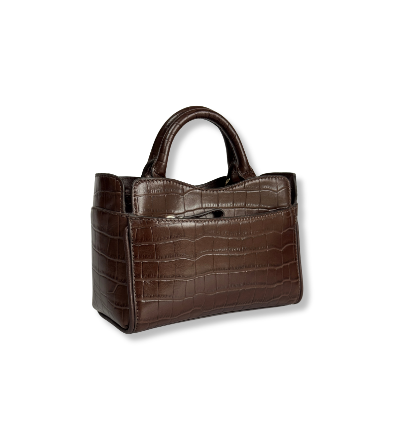 A brown crocodile-embossed leather handbag with dual top handles and a zippered front pocket, shown on a plain white background.
