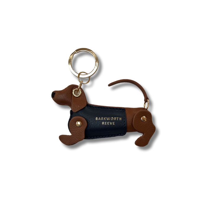 Tan & Navy sausage dog kweyring in a green coat. moving legs and tail. gold spit ring 