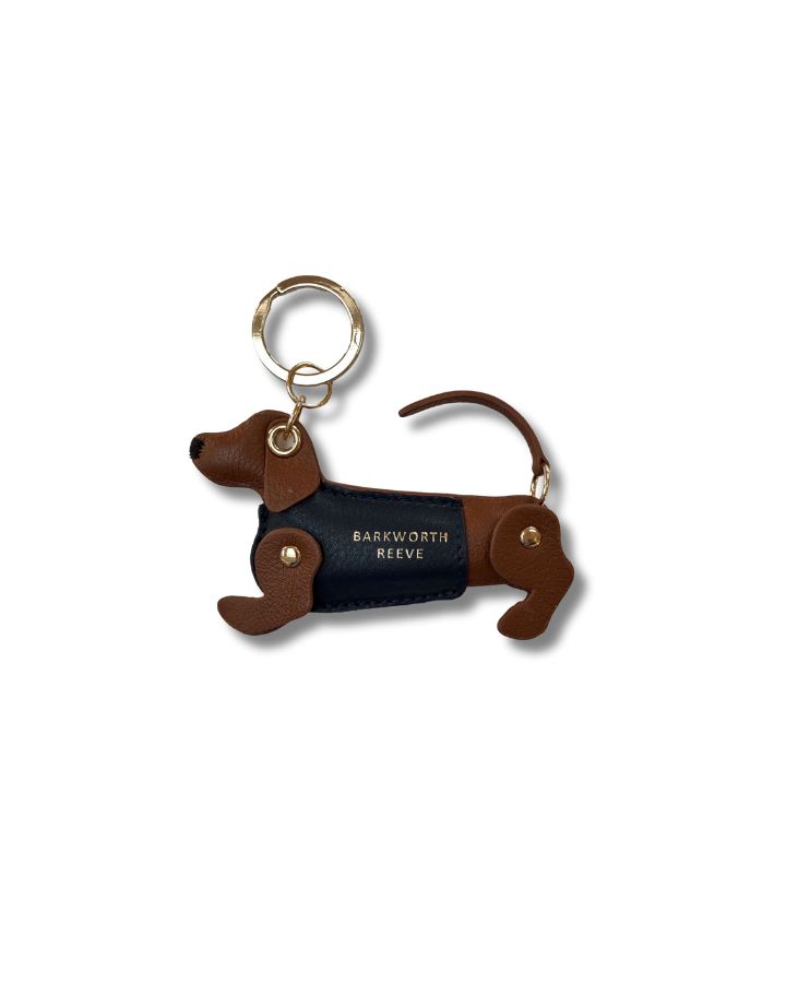 Tan & Navy sausage dog kweyring in a green coat. moving legs and tail. gold spit ring 