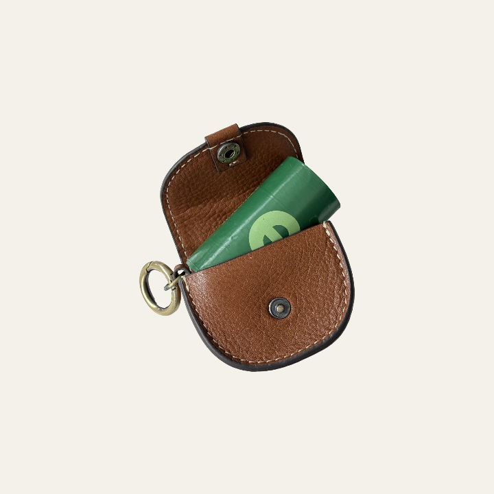 LEATHER POUCH WITH POPPER AND HOLDING A ROLL OF DOG POOP BAGS 