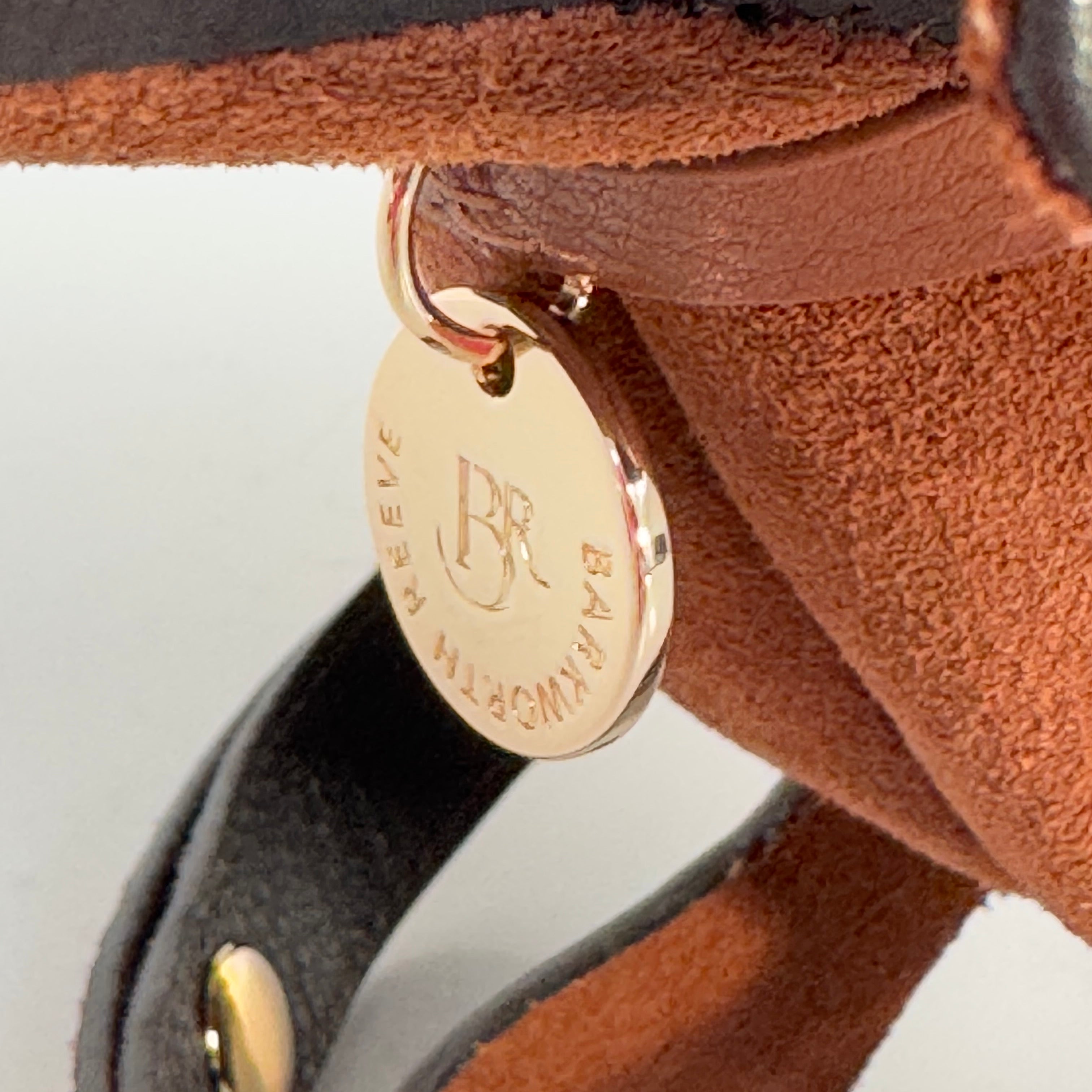 branded barkworth reeve disc on collar tab on the sausage dog bag. high shine gold colour 