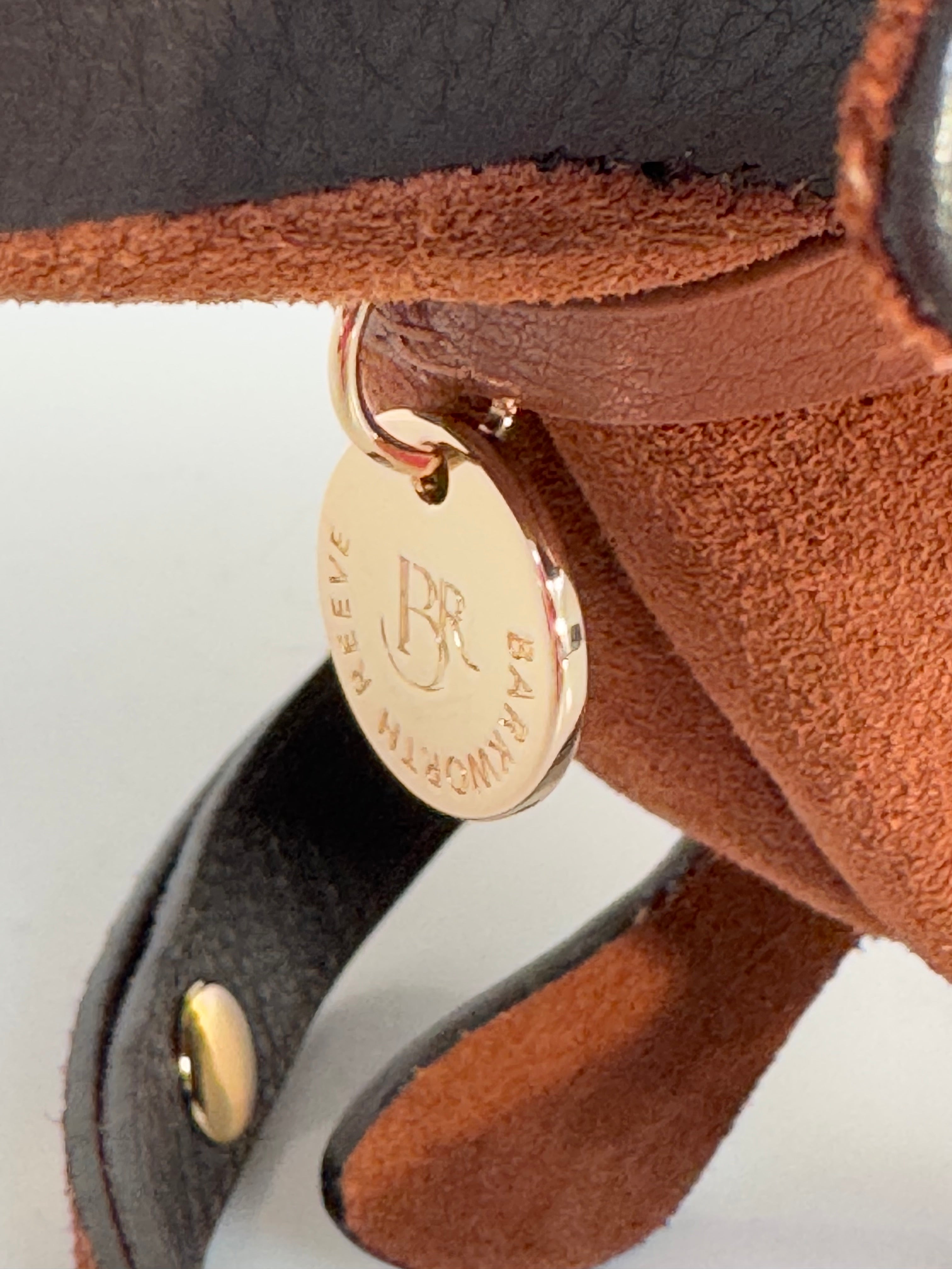 branded barkworth reeve disc on collar tab on the sausage dog bag. high shine gold colour 