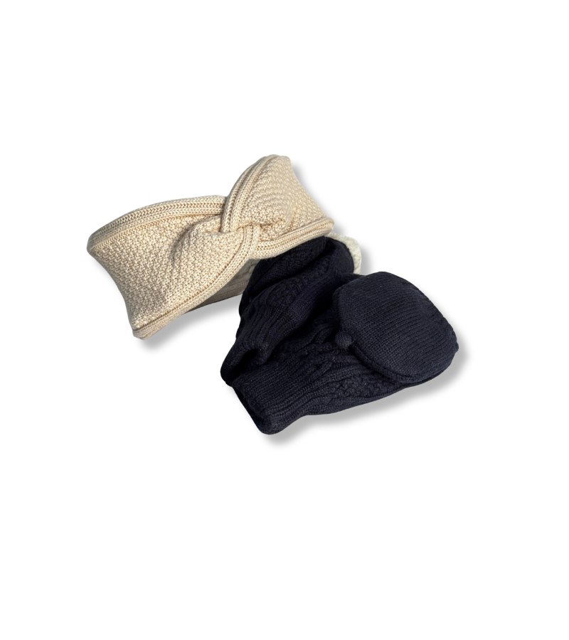 A baby knit hat set featuring a twisted headband in cream and a pair of booties in dark navy blue, displayed on a clean white background.