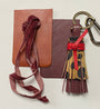 leopard tassel with red leather tie with leather swatches