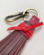 red and pink tassle keyring zoomed in with gold splid ring and hardwear 