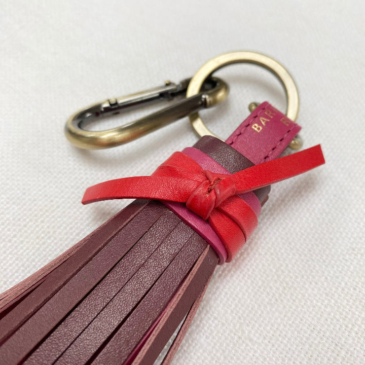 red and pink tassle keyring zoomed in with gold splid ring and hardwear 