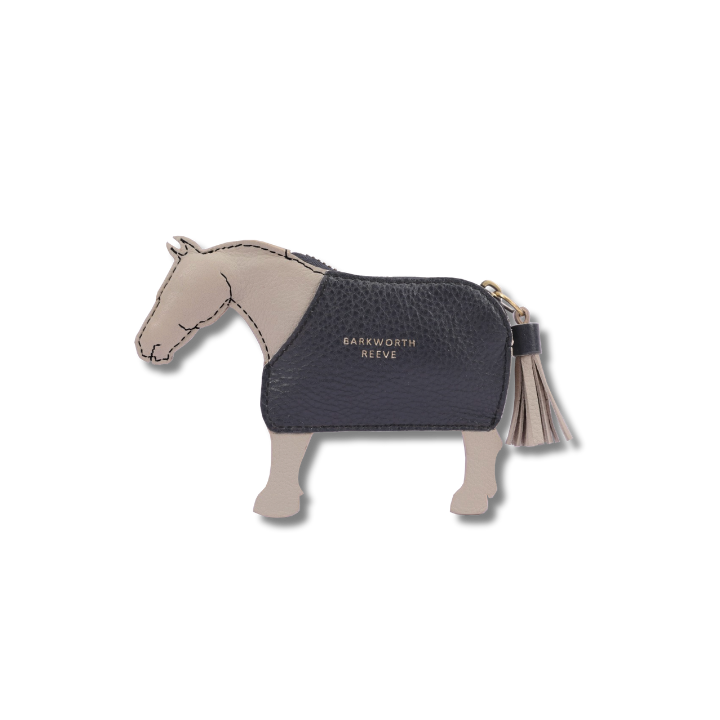light grey leather coin purse in the shape of a pony with a navy coat. tassel tail zipper