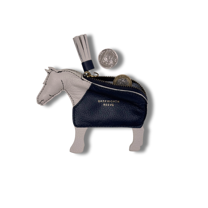 light grey leather coin purse in the shape of a pony with a navy coat.open with change coming out and tassel tail zipper
