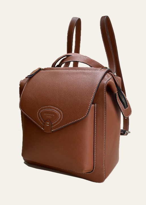 A tan leather rucksack with adjustable shoulder straps and a front flap closure.