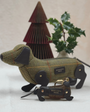 Sausage dog pencil case and keyring in front of paper christmas tree and foliage